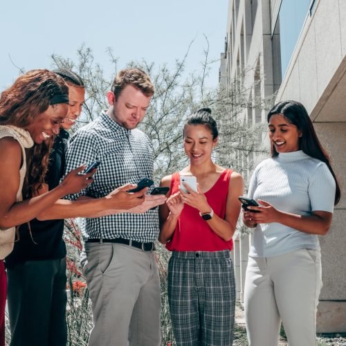 group of people using cellphones